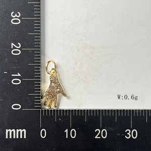 Macro shot of 15x11mm Hamsa hand pendant with gold plating and sparkling zircon stones