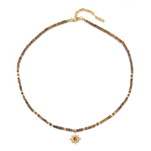 Natural tiger eye beaded necklace with a golden sun flower pendant on white background