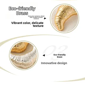 Detailed macro view of silver and gold brass croissant brooches with ribbed texture