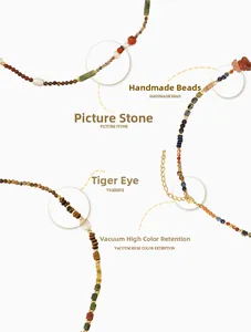 Detail of handmade necklace with tiger eye, picture stone, pearl and gold plated beads