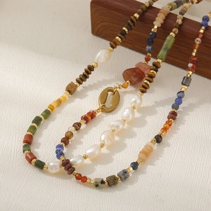 Retro multi-stone necklace featuring tiger eye, freshwater pearls, and golden shell clasp