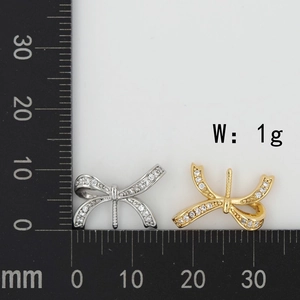 Micro-set cubic zirconia bow pendant showing 15mm width measurement on a ruler scale