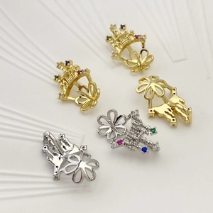 Detailed macro view of five micro-paved cubic zirconia crown and flower jewelry charms