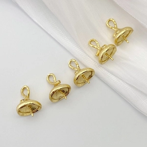 Macro detail of five gold-plated zircon bead caps and connectors for jewelry making