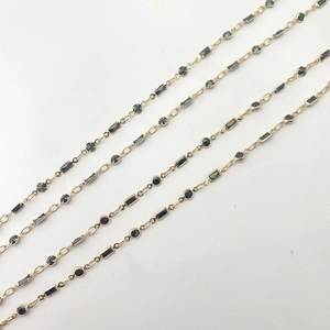 Detail view of gold chain necklaces with black zircon geometric charms for DIY jewelry making