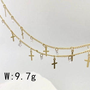 Macro detail of gold chain with cross pendants and clear zircon stones weighing 9.7g