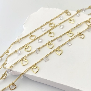 Detail of gold-plated chain with hollow heart charms and clear square zircon stones