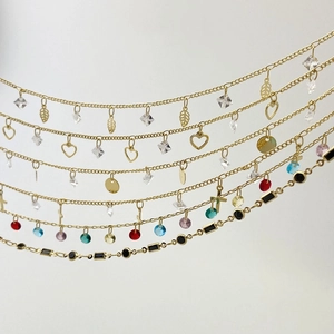 Detail of colorful cubic zirconia charms on golden chain for DIY jewelry making