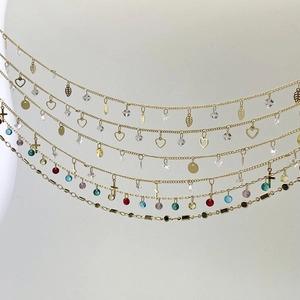 Detailed view of colorful zircon charms and gold-plated chains for DIY jewelry making