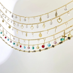 Gold chain necklaces featuring colorful zircon stones and geometric charms