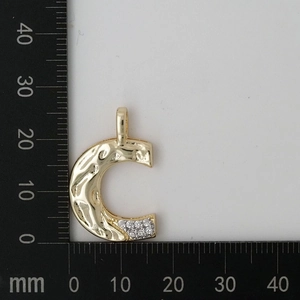 Detailed view of gold C pendant with hammered texture and paved zircons on a scale