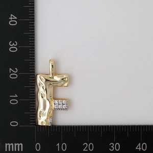 Detail view of gold letter F pendant with zircon inlay showing dimensions of 24mm by 18mm