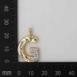 Macro detail of G letter pendant with zircon and lava texture showing 25mm dimensions