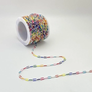 Detail of colorful enamel paperclip chain on white spool for DIY jewelry making projects