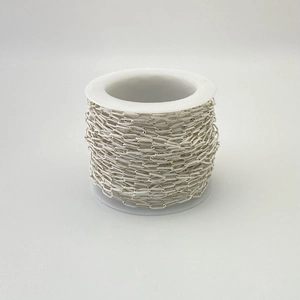 Close-up of a bulk roll of silver square link chain for DIY jewelry making and crafts