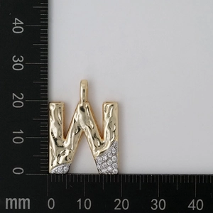 Detail view of gold letter W pendant with zircon inlays and dimensions 22mm x 22mm