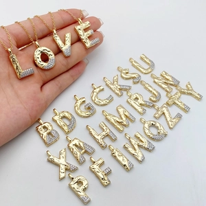 Golden 26-letter pendant necklace with lava texture and sparkling cubic zirconia stones