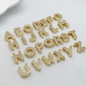Macro detail of gold plated 26 alphabet slide beads with micro paved cubic zirconia