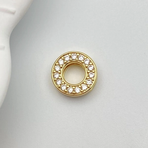 Macro detail of gold-plated charm ring with micro-pave white cubic zirconia inlay