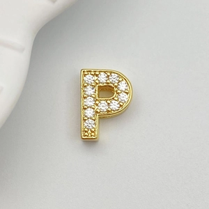 Detail of gold-plated letter P charm with pave-set white cubic zirconia stones