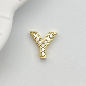 Detailed macro view of a gold letter Y charm pendant with pave white cubic zirconia stones