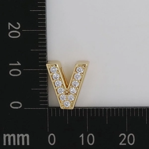 Macro view of gold V-shaped charm with white zircon pavé setting and 12mm size measurement