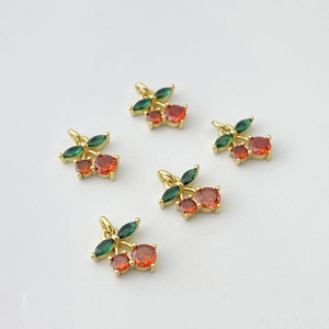 Detail view of five cherry pendants with red round gems and green marquise leaf stones