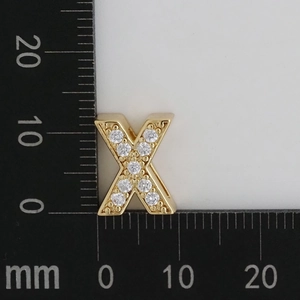 Macro detail of gold-plated letter X pendant with white zircon pavé setting and dimensions