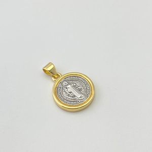 Detailed macro view of two-tone St. Benedict medal pendant with silver and gold finish