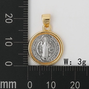 Macro detail of a 20mm Saint Benedict medal pendant with gold and silver dual-tone finish