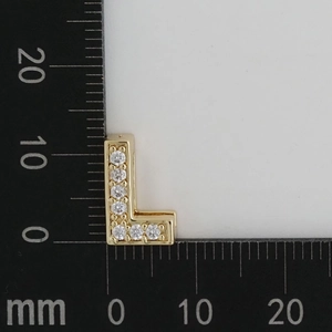 Detailed view of gold letter L pendant with white zircons showing 11mm height on scale