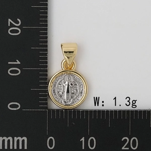 Macro detail of a two-tone Saint Benedict medal pendant showing 12mm size on scale