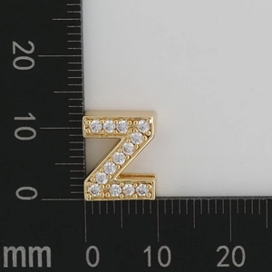 Macro shot of gold-plated Z-letter charm with white zircon stones measuring 10mm x 10mm