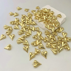 Detail shot of 3D gold heart charms with polished finish for DIY jewelry necklaces