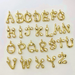 Detailed grid of A-Z letter pendants with cubic zirconia inlay on polished gold plating