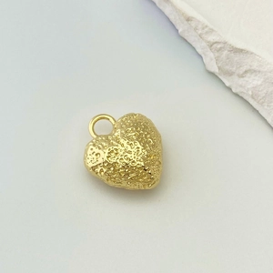 Detailed view of a golden heart pendant featuring a unique 3D molten lava texture