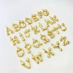 Collection of 26 gold letter pendants with teardrop lava texture and pavé zircon stones