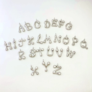Macro shot of 26 alphabet drop pendants with micro-inlaid cubic zirconia silver finish