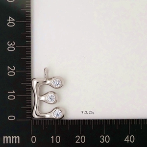 Macro shot of silver letter E pendant with cubic zirconia, weighing 3.25g and 20mm high