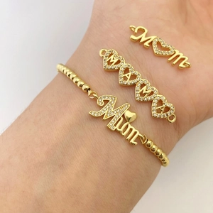 Close-up of gold MOM bracelet with zircons and heart details for Mother's Day gift