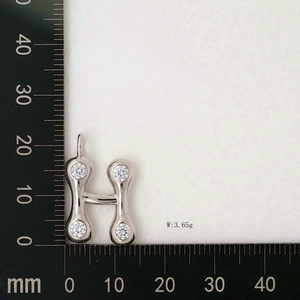 Detail view of water drop letter H pendant with zircons showing size and 3.65g weight