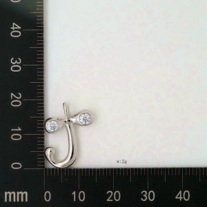 Detailed view of silver letter J pendant with cubic zirconia and size scale display