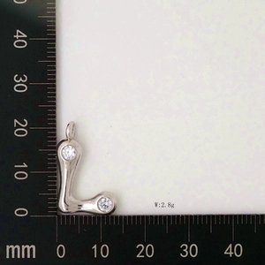 Detail showing letter L pendant size with white zircons and silver metal texture