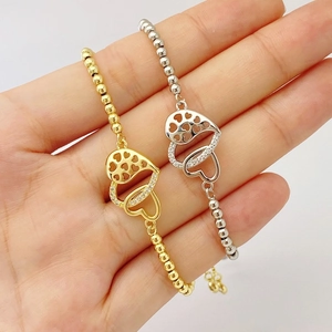 Close-up of MOM double heart charm bracelet with sparkling crystals in gold and silver