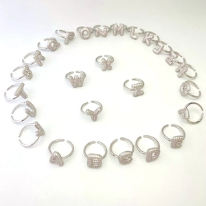 Macro shot of 26 alphabet rings with sparkling cubic zirconia on a white background