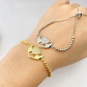 Detail of adjustable heart wing bracelet with micro-paved zircons and slide clasp