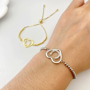 Detail of adjustable heart and horseshoe charm bracelet with sparkling cubic zirconia