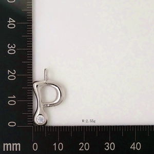 Letter P pendant with white zircon and 2.55g weight measurement on a metric scale