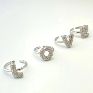 Sparkling silver cubic zirconia ring set spelling LOVE with adjustable open band design
