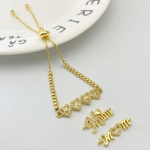 Detail of gold adjustable charm bracelet with crystal MAMA and heart pendants